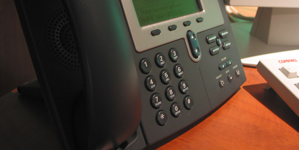 office VOIP phone rests on a desk